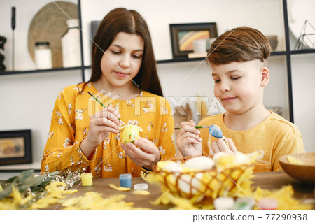 Brother and sister are preparing for Easter Brother and sister are preparing for Easter 77290938