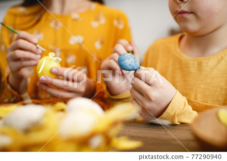 Brother and sister are preparing for Easter Brother and sister are preparing for Easter 77290940
