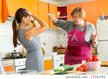 Unhappy senior woman during quarreling with upset daughter Unhappy senior woman during quarreling with upset daughter 77291763