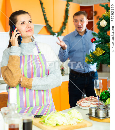 Young woman after quarrel with husband, he trying conversate 77292139