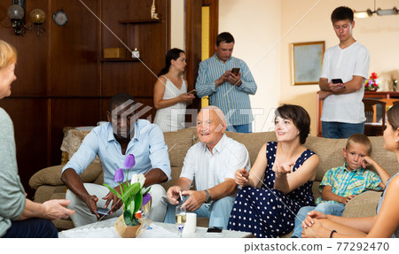 Portrait of big multigenerational family using gadgets at home Portrait of big multigenerational family using gadgets at home 77292470