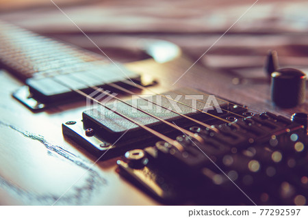 Closeup of wooden electric guitar with six strings 77292597