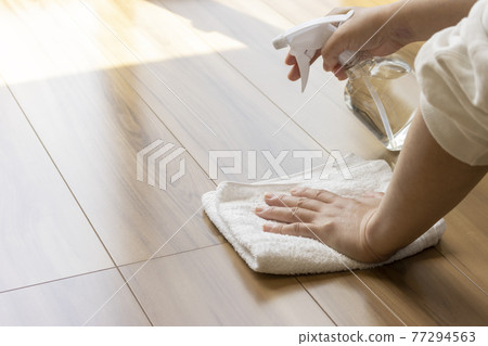 Towels and alcohol spray and women. Image of disinfecting the floor with alcohol 77294563