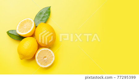 Fresh ripe lemons on yellow background Fresh ripe lemons on yellow background 77295399
