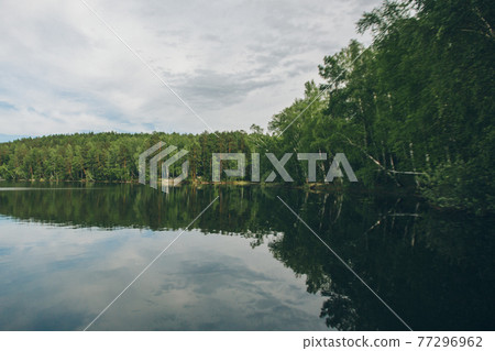 the concept of weather observation, meteorology. wind and small waves. Landscape by the river, trees and sandy beach the concept of weather observation, meteorology. wind and small waves. Landscape by the river, trees and sandy beach 77296962
