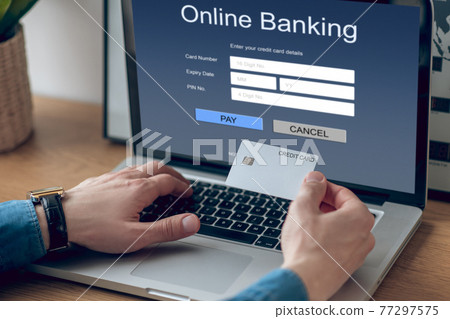 Close up picture of mans hands holding a credit card Close up picture of mans hands holding a credit card 77297575