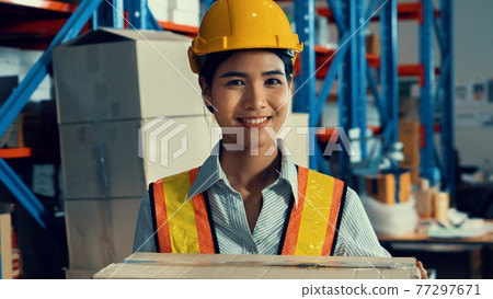 Portrait of young Asian woman warehouse worker smiling in the storehouse 77297671