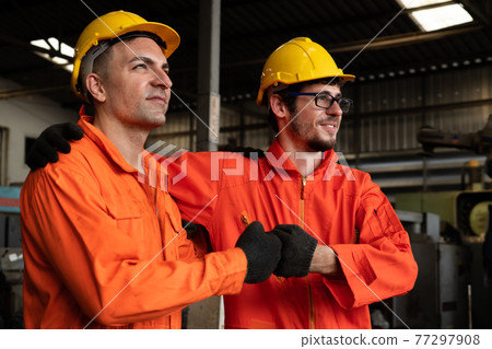 Two skillful factory engineer or worker showing teamwork and partnership . Two skillful factory engineer or worker showing teamwork and partnership . 77297908