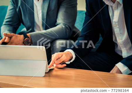 Businessmen are in business meeting in office. 77298164