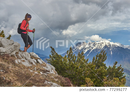 Descent girl during an alpine trekking 77299277
