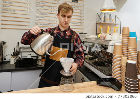 Professional barista man making coffee at the coffee shop. 77302866