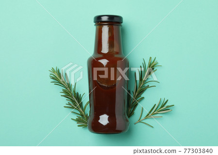 Bottle of barbecue sauce and rosemary on mint background 77303840