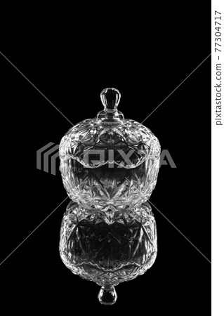 crystal candy with a lid, on a black mirror background crystal candy with a lid, on a black mirror background 77304717