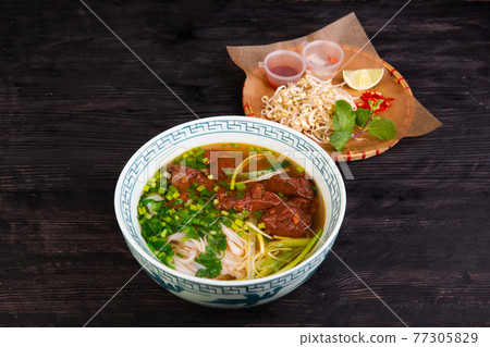 boiled lamb in broth with rice noodles, chopped green onions, lime and pepper boiled lamb in broth with rice noodles, chopped green onions, lime and pepper 77305829