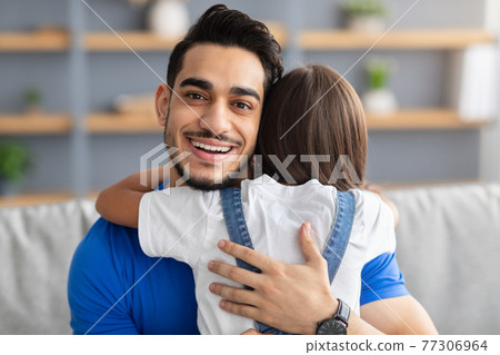 Portrait of father and daughter hugging at home Portrait of father and daughter hugging at home 77306964