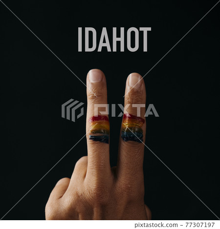 V sign, rainbow flag and text IDAHOT 77307197