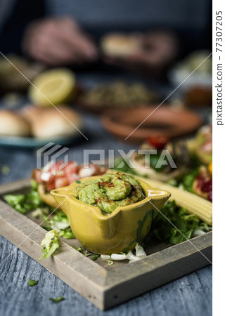 guacamole and vegan sandwiches in a tray 77307205