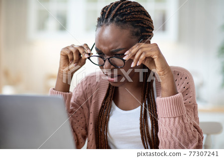 Eyesight Problems. Black Lady In Glasses Squinting While Looking At Laptop Screen 77307241