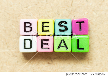 Color alphabet letter block in word best deal on wood background Color alphabet letter block in word best deal on wood background 77308587