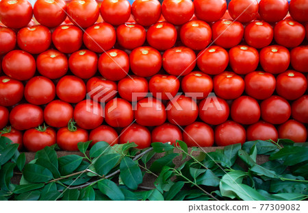 Red ripe tasty fresh delicious tomato vegetables in bazaar market 77309082