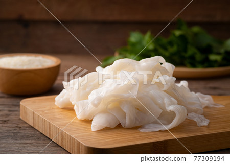 Thai Raw Big flat noodles on wood board,Uncooked Thai Raw Big flat noodles on wood board,Uncooked 77309194