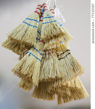 Set of yellow straw broom in bazaar Set of yellow straw broom in bazaar 77310387