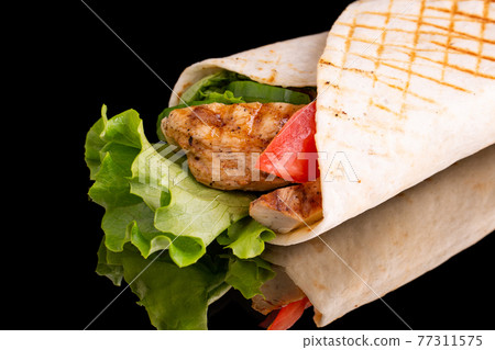 Tortilla with chicken, lettuce, fresh tomato, grilled 77311575