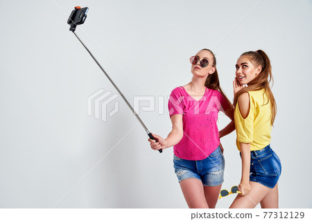 portrait of happy teenagers taking selfie together isolated on whitePortrait of happy teenagers in summer clothes, sunglasses taking selfie together isolated on white. portrait of happy teenagers taking selfie together isolated on whitePortrait of happy teenagers in summer clothes, sunglasses taking selfie together isolated on white. 77312129