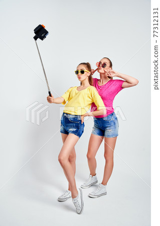 portrait of happy teenagers taking selfie together isolated on whitePortrait of happy teenagers in summer clothes, sunglasses taking selfie together isolated on white. portrait of happy teenagers taking selfie together isolated on whitePortrait of happy teenagers in summer clothes, sunglasses taking selfie together isolated on white. 77312131