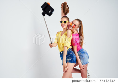 portrait of happy teenagers taking selfie together isolated on whitePortrait of happy teenagers in summer clothes, sunglasses taking selfie together isolated on white. portrait of happy teenagers taking selfie together isolated on whitePortrait of happy teenagers in summer clothes, sunglasses taking selfie together isolated on white. 77312132