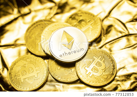 Gold ethereum coins on a golden background. Trading on the cryptocurrency exchange. Cryptocurrency Stock Market Concept. Virtual money concept. Mining or blockchain technology. Business concept. 77312853