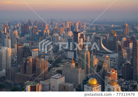 Aerial view of Bangkok Downtown Skyline, Thailand. Financial district and business centers in smart urban city in Asia. Skyscraper and high-rise buildings at sunset. Aerial view of Bangkok Downtown Skyline, Thailand. Financial district and business centers in smart urban city in Asia. Skyscraper and high-rise buildings at sunset. 77313479