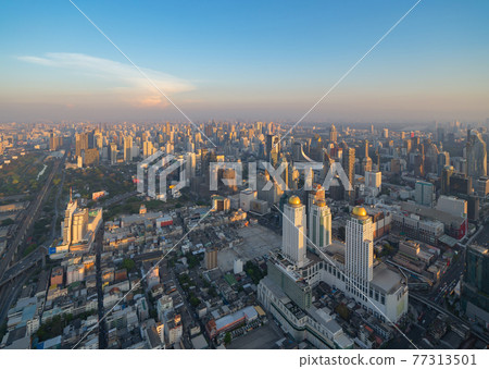 Aerial view of Bangkok Downtown Skyline, Thailand. Financial district and business centers in smart urban city in Asia. Skyscraper and high-rise buildings at sunset. Aerial view of Bangkok Downtown Skyline, Thailand. Financial district and business centers in smart urban city in Asia. Skyscraper and high-rise buildings at sunset. 77313501