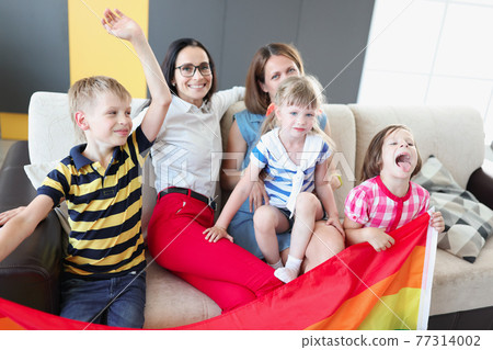 Lgbt family two women with joyful children hold flag Lgbt family two women with joyful children hold flag 77314002
