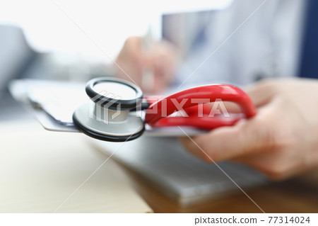 In hands of doctor stethoscope clipboard with documents 77314024