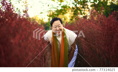 Asian senior woman smile happy in red flower field happy leisure retirement lifestyle Asian senior woman smile happy in red flower field happy leisure retirement lifestyle 77314025