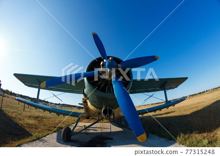 old plane stands in the field 77315248