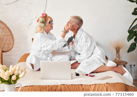 Woman doing make up Woman doing make up 77315460