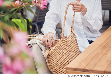 Close up of girl opening her bag 77316423