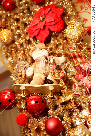 Christmas gold garland with snowman on skate and red balls. Art decoration Christmas gold garland with snowman on skate and red balls. Art decoration 77316643