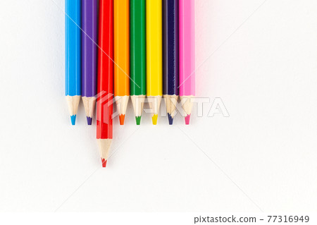 Bright colored pencils on a white paper background Bright colored pencils on a white paper background 77316949