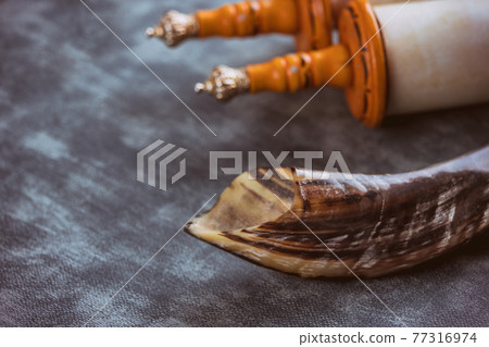 Shofar horn jewish religious symbols on soft focus Jewish torah scroll Shofar horn jewish religious symbols on soft focus Jewish torah scroll 77316974