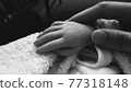 Baby and Mommy's hand 77318148