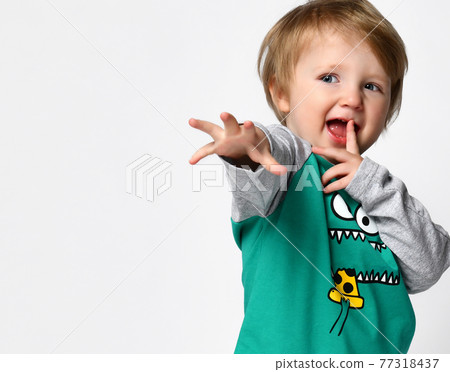 Little preschool toddler boy with hand reaching to Little preschool toddler boy with hand reaching to 77318437