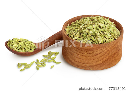 Dried fennel seeds in wooden bowl isolated on white background with clipping path and full depth of field 77318491
