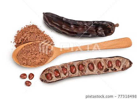 Carob pod and powder in wooden spoon isolated on white background with clipping path. Top view. Flat lay Carob pod and powder in wooden spoon isolated on white background with clipping path. Top view. Flat lay 77318498