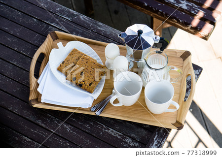 Breakfast for two on an old table in the summer garden 77318999