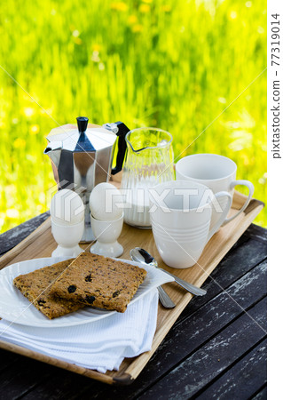 Breakfast for two on an old table in the summer garden Breakfast for two on an old table in the summer garden 77319014