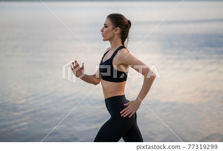 fitness and lifestyle concept - woman doing sports outdoors on a beach fitness and lifestyle concept - woman doing sports outdoors on a beach 77319299