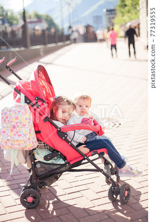little baby in stroller outdoor. Happy family little baby in stroller outdoor. Happy family 77319555